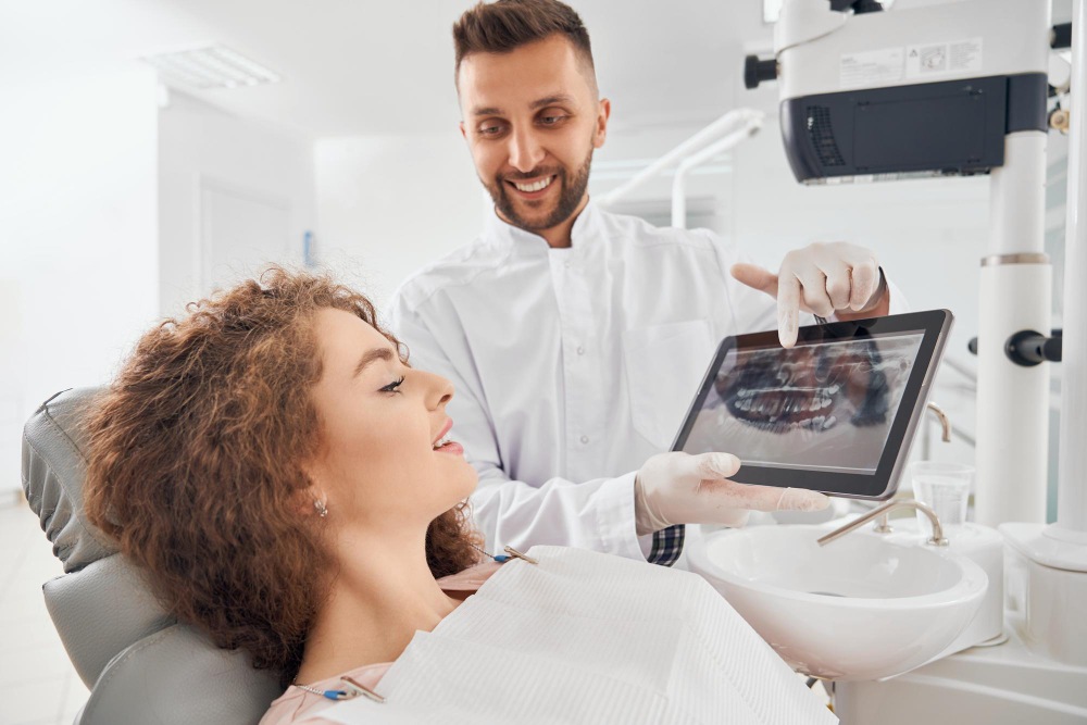 Periodontist reviewing digital x-rays with a patient