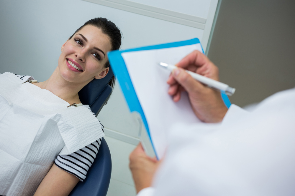 Patient filling out forms before a dental appointment